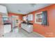 Cozy eat-in kitchen features bright walls, white cabinets, tile floor, and a double window at 5028 Edward St, Charlotte, NC 28213