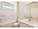 Well-lit bathroom with a shower-tub combo and a vanity, offering functionality and comfort at 5944 Oak Branch Cir, Maiden, NC 28650