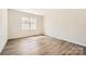 Inviting bedroom with hardwood flooring and a window offering natural light and pleasant views at 5944 Oak Branch Cir, Maiden, NC 28650