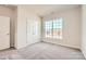 Comfortable bedroom with soft carpet, a double-door closet, and a large window providing natural light at 5944 Oak Branch Cir, Maiden, NC 28650