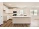 Stylish kitchen featuring white cabinets, quartz countertops, and a spacious island for food preparation at 5944 Oak Branch Cir, Maiden, NC 28650