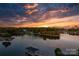 Breathtaking aerial view of a serene lake community at sunset, featuring vibrant colors at 6233 Riviera Run Estates Dr, Hickory, NC 28601