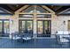 View of outdoor back porch with a black table and white patio furniture at 6233 Riviera Run Estates Dr, Hickory, NC 28601