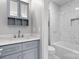 Bathroom featuring gray vanity with white countertop and a marble-look tiled shower at 6233 Riviera Run Estates Dr, Hickory, NC 28601