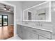 Bright bathroom featuring a dual vanity, marble countertops, and a lighted mirror at 6233 Riviera Run Estates Dr, Hickory, NC 28601