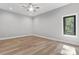 This bedroom features hardwood floors, a ceiling fan, and a wooded view at 6233 Riviera Run Estates Dr, Hickory, NC 28601