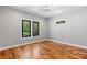 Bright bedroom with hardwood floors, recessed lighting, and plenty of natural light from the large windows at 6233 Riviera Run Estates Dr, Hickory, NC 28601