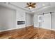 Bedroom featuring a modern fireplace, a ceiling fan, and a barn door to the bathroom at 6233 Riviera Run Estates Dr, Hickory, NC 28601