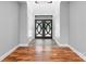 Bright foyer with elegant double doors, hardwood floors, stylish lighting and an adjacent closet at 6233 Riviera Run Estates Dr, Hickory, NC 28601