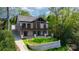 Stunning brick home with a black metal balcony on two levels, overlooking a beautifully landscaped lawn and stone retaining wall at 6233 Riviera Run Estates Dr, Hickory, NC 28601