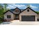 Beautiful home featuring a brick facade, double-door entry, a two-car garage, and professional landscaping at 6233 Riviera Run Estates Dr, Hickory, NC 28601