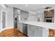 Open-concept kitchen features a large island, stainless steel appliances, and gray cabinetry at 6233 Riviera Run Estates Dr, Hickory, NC 28601