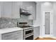 Elegant kitchen boasts stainless appliances, subway tile backsplash and a pantry with a glass door at 6233 Riviera Run Estates Dr, Hickory, NC 28601