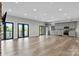 Spacious living area with wood floors, exterior access and gray kitchen cabinets at 6233 Riviera Run Estates Dr, Hickory, NC 28601