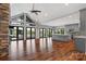 Spacious living room featuring wood floors, stone fireplace, lots of windows, and an island with kitchen at 6233 Riviera Run Estates Dr, Hickory, NC 28601