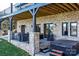 Rear patio with brick columns, hot tub, and lake views at 6233 Riviera Run Estates Dr, Hickory, NC 28601