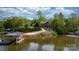 Beautiful waterfront property featuring a home and dock with lovely lake views surrounded by lush greenery at 6233 Riviera Run Estates Dr, Hickory, NC 28601