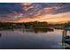Scenic lake view showcasing a colorful sunset reflecting on the calm waters and waterfront homes at 6233 Riviera Run Estates Dr, Hickory, NC 28601