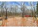 Spacious outdoor deck with wood flooring and sleek metal railing that is surrounded by mature trees at 642 Brynwood Dr, Rock Hill, SC 29732