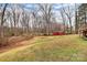 Lush backyard featuring mature trees, a vibrant storage shed, and plenty of green space at 642 Brynwood Dr, Rock Hill, SC 29732