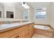 Bathroom featuring double sinks, a soaking tub and tile floors at 642 Brynwood Dr, Rock Hill, SC 29732
