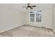 Carpeted bedroom featuring a ceiling fan and a large window at 642 Brynwood Dr, Rock Hill, SC 29732