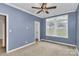 Bedroom features blue walls, a ceiling fan, and a large window at 642 Brynwood Dr, Rock Hill, SC 29732