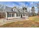 Side view of a well-maintained house with light siding, black shutters, dormer windows, and a shingled roof at 642 Brynwood Dr, Rock Hill, SC 29732