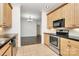 Functional kitchen showcasing stainless steel appliances, black countertops, and wood cabinetry at 642 Brynwood Dr, Rock Hill, SC 29732