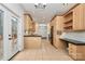 Well-lit kitchen with wooden cabinets, black appliances, tiled floors, and access to a deck at 642 Brynwood Dr, Rock Hill, SC 29732