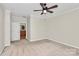 Large carpeted main bedroom featuring a ceiling fan and an ensuite bathroom at 642 Brynwood Dr, Rock Hill, SC 29732