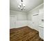 Well-lit dining room featuring hardwood floors, wainscoting, stylish lighting, and neutral paint at 712 S Academy St, Mooresville, NC 28115