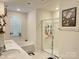 Bathroom featuring a glass-enclosed shower, bathtub, dual vanity, and decorative wall art at 7711 Bainbridge Rd, Sherrills Ford, NC 28673