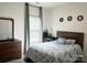 Comfortable bedroom with wooden furniture set, soft gray bedding, and natural light from the window at 7711 Bainbridge Rd, Sherrills Ford, NC 28673