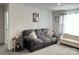 Cozy living room featuring a comfortable sofa, round side table, and natural light from a window at 7711 Bainbridge Rd, Sherrills Ford, NC 28673