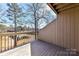View from wooden deck overlooking wooded area with lake in the background at 84 Ridgeport Rd # B, Clover, SC 29710