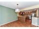 Dining area adjacent to kitchen featuring hardwood floors and view to kitchen and stainless appliances at 84 Ridgeport Rd # B, Clover, SC 29710