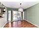 Well-lit dining area adjacent to a sliding door to an outdoor deck, with pendant lighting at 84 Ridgeport Rd # B, Clover, SC 29710