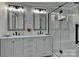 This bathroom features a marble countertop, a large mirror, and a glass-enclosed shower at 9414 Machado Dr, Indian Trail, NC 28079