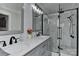 Modern bathroom featuring a sleek vanity with double sinks, and a glass-enclosed shower at 9414 Machado Dr, Indian Trail, NC 28079
