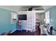 A bedroom with an open loft, a desk, and a window with an air conditioning unit at 9414 Machado Dr, Indian Trail, NC 28079