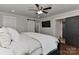Bedroom featuring a sliding barn door to ensuite bath, ceiling fan and hardwood floors at 9414 Machado Dr, Indian Trail, NC 28079