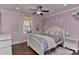 A bedroom with a white bed, pink walls, and a ceiling fan at 9414 Machado Dr, Indian Trail, NC 28079