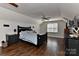 This bedroom is designed with wood floors, black bedroom furniture, and decorated with football memorabilia at 9414 Machado Dr, Indian Trail, NC 28079