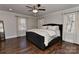 This bedroom has hardwood floors, a ceiling fan, and large windows at 9414 Machado Dr, Indian Trail, NC 28079