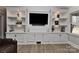 Built-in shelves with cabinets showcasing decorative items and a mounted television at 9414 Machado Dr, Indian Trail, NC 28079