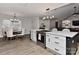 Open kitchen featuring a stainless steel oven, white cabinetry, and a dining area bathed in natural light at 9414 Machado Dr, Indian Trail, NC 28079