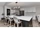 Modern kitchen boasts a large island with bar seating and stainless steel appliances, perfect for entertaining at 9414 Machado Dr, Indian Trail, NC 28079