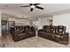 Open-concept living space features comfortable leather seating and seamlessly connects to the kitchen and dining area at 9414 Machado Dr, Indian Trail, NC 28079