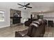 Bright living room featuring a stone fireplace and seamless connection to the kitchen at 9414 Machado Dr, Indian Trail, NC 28079
